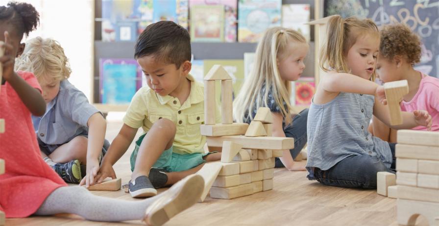 Kindergartenkinder spielen mit Bausteinen